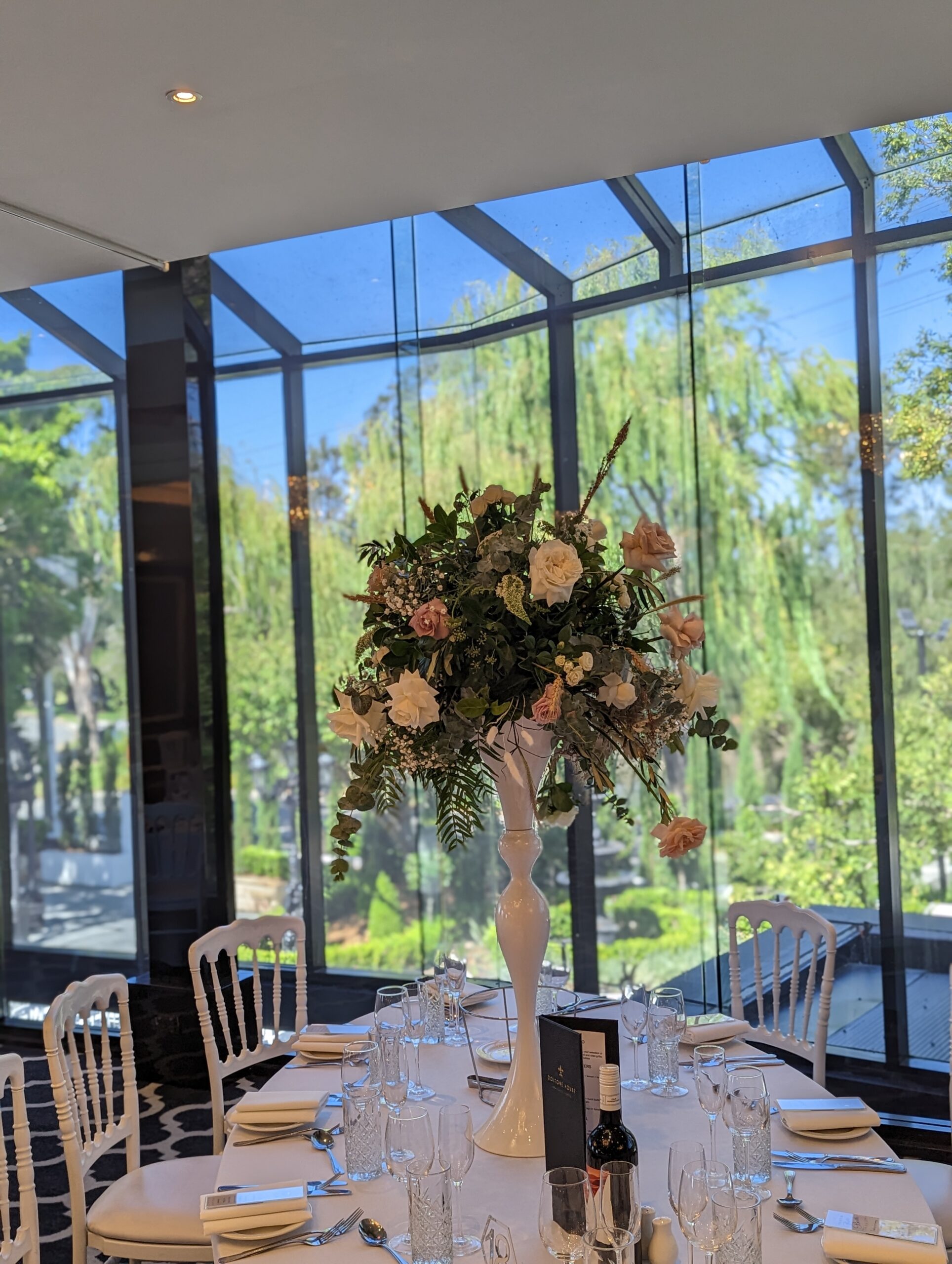 a table set with flowers in our metal vase
