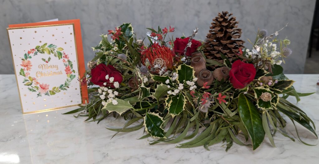arrangement of flowers with pine cones