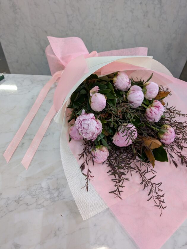 a bouquet of pink Peonies wrapped