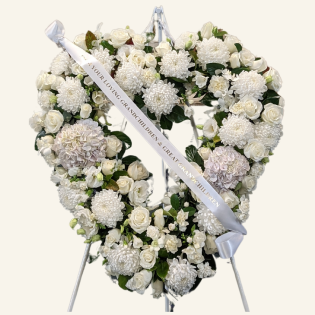 An elegant white heart tribute featuring roses, Disbuds, carnations, and lisianthus.